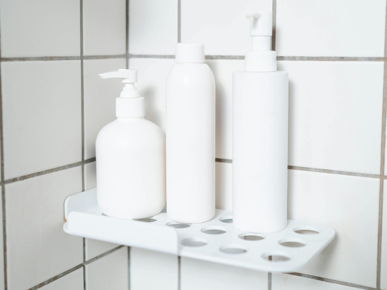 white-plastic-bottles-on-white-wall-tiles