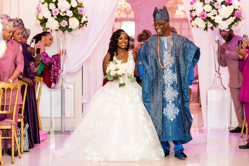 The bride and her father walk down the aisle