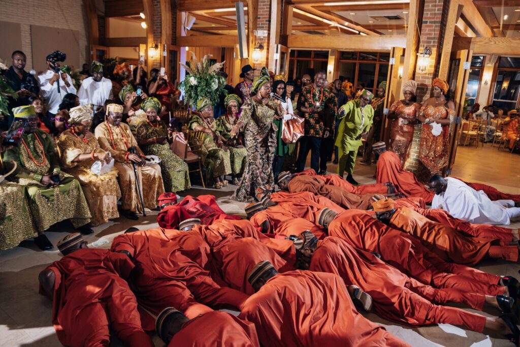 Groomsmen laying prostrate at a wedding as a greeting to bride's family