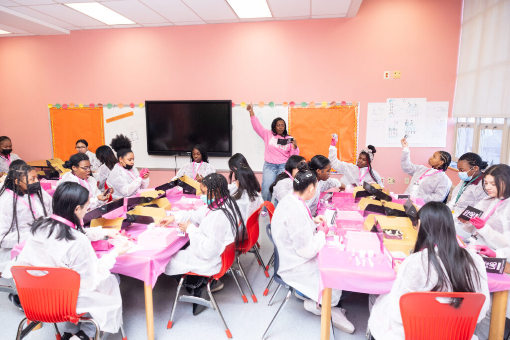 A female entrepreneur speaking to students in a classroom