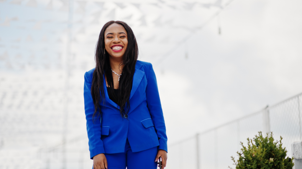 Black woman wearing a blue suit with a black shirt underneath