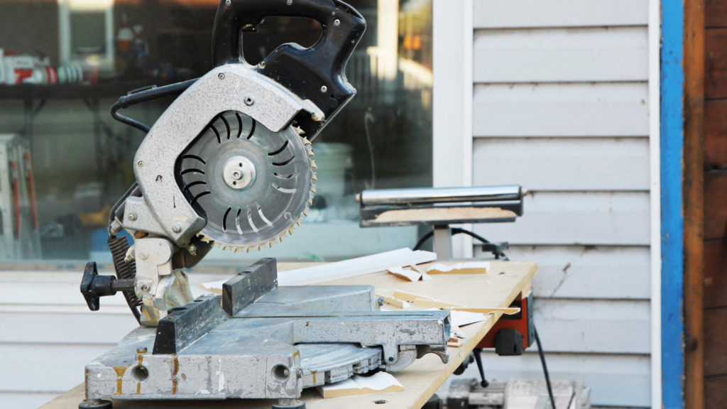 Miter saw on workbench outside of house