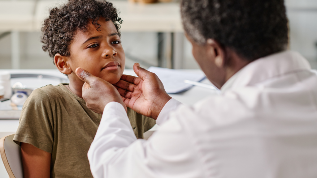 Pediatrician Examining Sore Throat of Boy