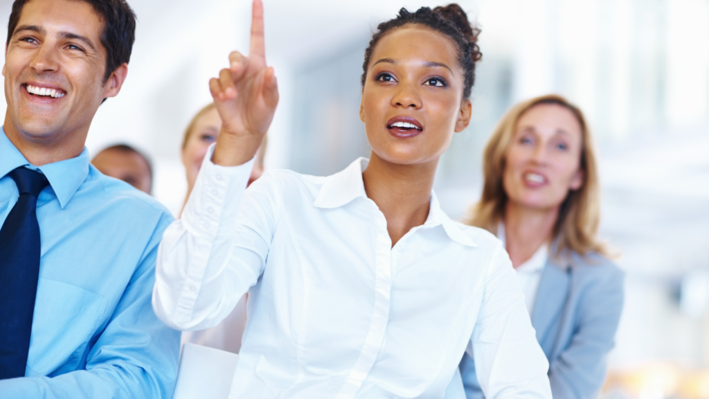 businesswoman raising hand to ask a question during a seminar