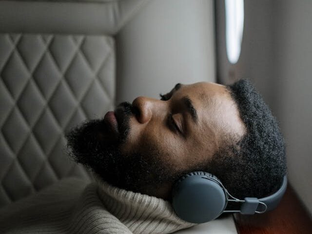 Black man sleeping on a plane