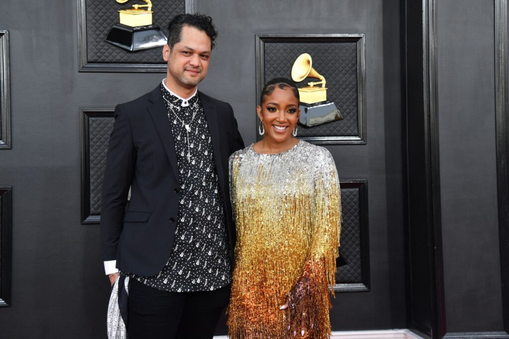 US singer Mickey Guyton (R) and husband Grant Savoy arrive for the 64th Annual Grammy Awards at the MGM Grand Garden Arena in Las Vegas on April 3, 2022.