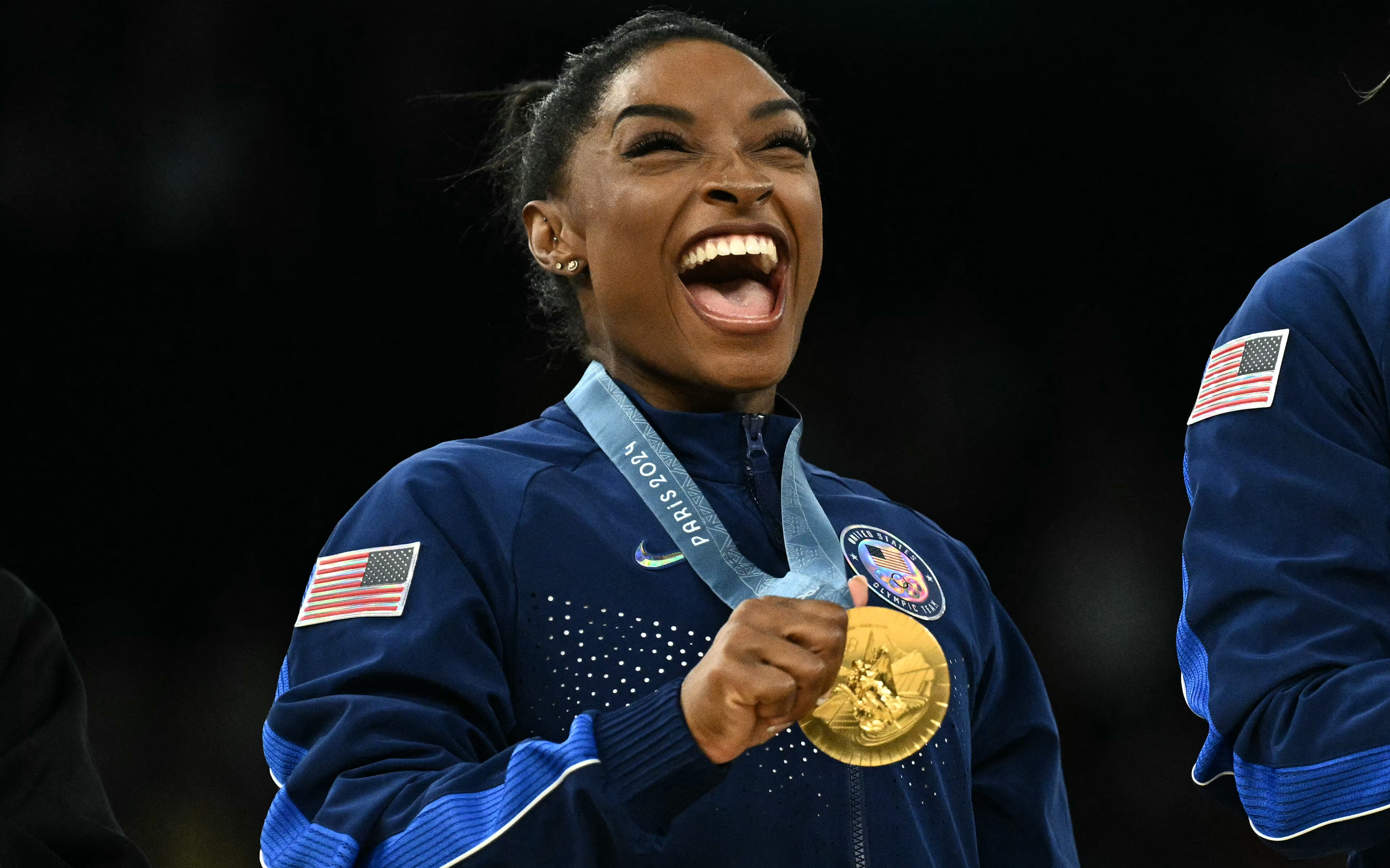 US' Simone Biles poses with the gold medal during the podium ceremony for the artistic gymnastics women's team final during the Paris 2024 Olympic Games at the Bercy Arena in Paris, on July 30, 2024.