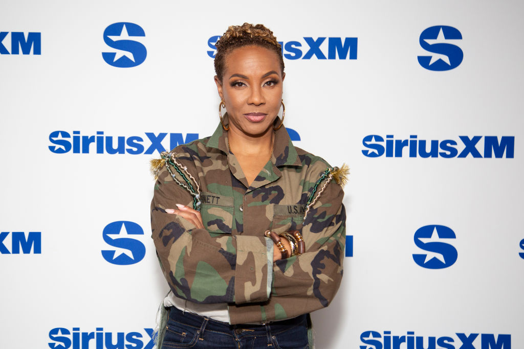 MC Lyte wears an army fatigue shirt while visiting SiriusXM Studios on August 07, 2024 in New York City. 