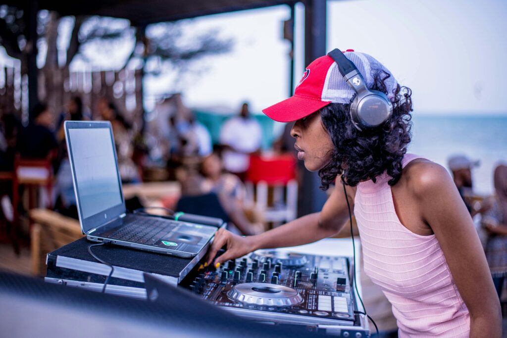 A black woman on a DJ turntable. edm-music-artists